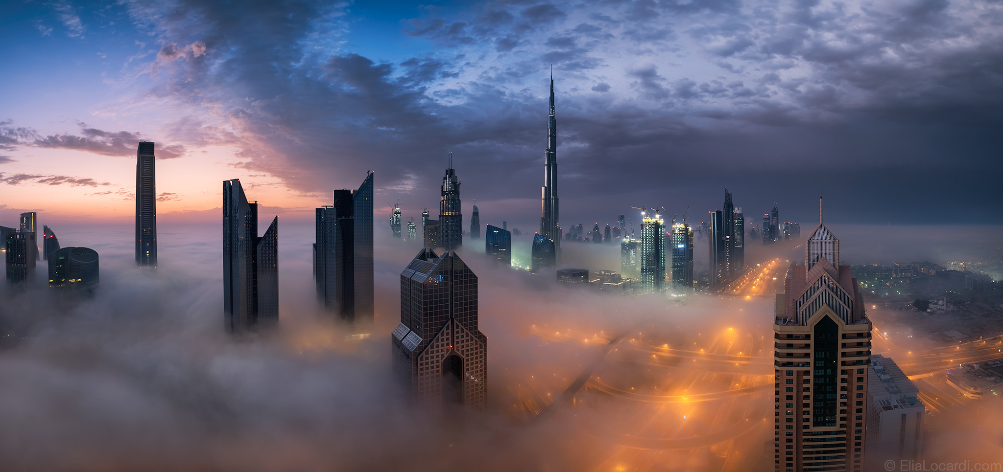 A breathtaking sunrise in Dubai as thick fog pours though the futuristic and beautiful city skyline.